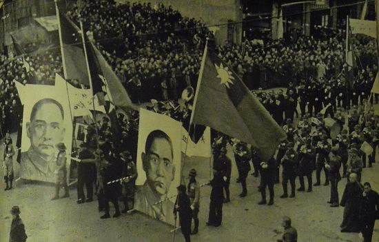 1938年，漢口的主要街道上，童子軍們和士兵們扛著孫中山像游行以示抗日決心，隊(duì)伍的最后跟著漢口的市民。