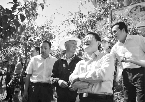 中央統(tǒng)戰(zhàn)部副部長(zhǎng)、全國工商聯(lián)黨組書記徐樂江（前排右一）、全國工商聯(lián)副主席謝經(jīng)榮（后排右一）、甘肅省工商聯(lián)主席郝遠(yuǎn)（前排左一）在甘肅省和政縣八八啤特果集團(tuán)的果樹基地調(diào)研。