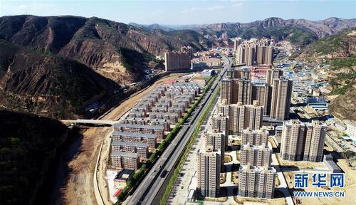 4月23日無人機(jī)拍攝的陜西延安安塞區(qū)位于道路兩側(cè)的惠澤園移民安置小區(qū)。 新華社記者 劉瀟 攝